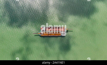 Old fishing boats on the sea off the coast of Malaysia from the sky. Aerial view to two old wooden Malaysian fisher boats on the lebam river near the Stock Photo