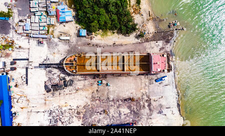 Old fishing boats on the sea off the coast of Malaysia from the sky. Aerial view to two old wooden Malaysian fisher boats on the lebam river near the Stock Photo