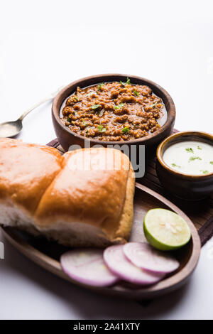 Kheema / keema Pav or Khima Paav is a spicy curry dish made up of minced chicken or lamb cooked with onion, tomatoes, served with buns. selective focu Stock Photo