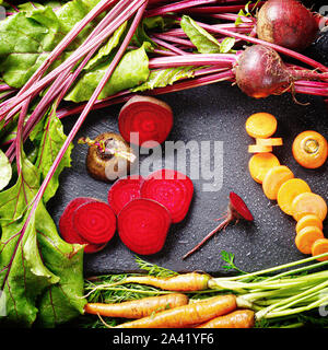 Top view at vegetable background of beets and carrots on kitchen table close up view Stock Photo