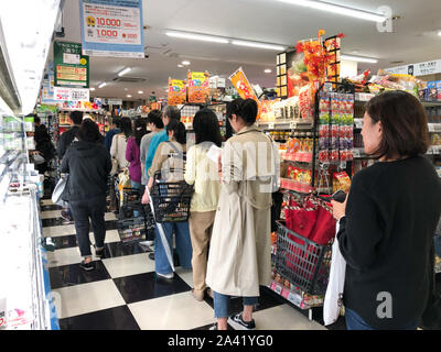 Tokyo, Japan. 11th Oct, 2019. People queue up for payment in a supermarket of Tokyo, capital of Japan, Oct. 11, 2019. A powerful typhoon is expected to hit Tokyo and wide swathes of eastern Japan this weekend, the weather agency here said Friday. According to the Japan Meteorological Agency (JMA), Typhoon Hagibis, the 19th and likely most powerful typhoon of the season, is expected to make landfall by Saturday evening. Credit: Ma Caoran/Xinhua/Alamy Live News Stock Photo