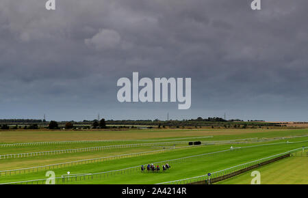 Runners and riders in action during The Godolphin Lifetime Care Oh So Sharp Stakes during day one of the Dubai Future Champions Festival at Newmarket Racecourse. Stock Photo