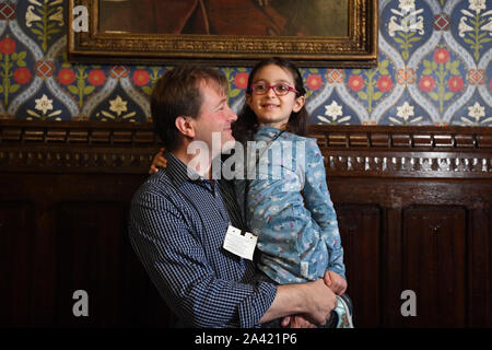 Five-year-old Gabriella Zaghari-Ratcliffe carries a cake to her father Richard Ratcliffe during a press conference in the Jubilee Room at the Houses of Parliament in Westminster, following Gabriella's return to the UK so she can attend school. PA Photo. Picture date: Friday October 11, 2019. Gabriella had been living in Iran where her mother, Nazanin Zaghari-Ratcliffe, has been detained in Evin prison by the government since April 2016. See PA story POLITICS Iran. Photo credit should read: Victoria Jones/PA Wire