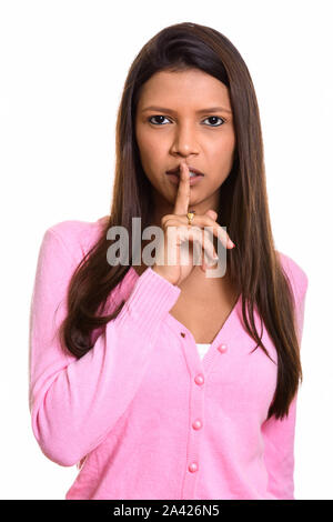 Brazilian woman with finger on lips looking at camera Stock Photo