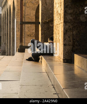 Relaxing on the stairs in the Brescia city center. Stock Photo