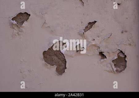 Old cracked and peeling plastered wall. Stock Photo