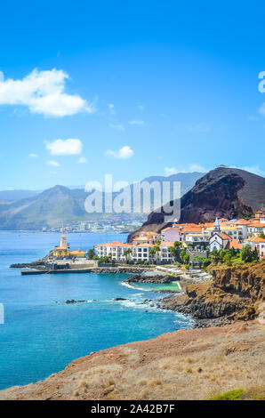 Picturesque Marina da Quinta Grande in Portuguese island Madeira. Small village, harbor located by Ponta de Sao Lourenco. Rocks and hills behind the city by the Atlantic ocean. Cities. Travel spot. Stock Photo