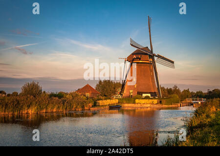 Traditional dutch windmill "Rietveldse Molen" in Hazerswoude, Holland during golden hour. Stock Photo