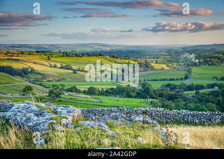 The view from the top of Malham cove across the valley to the village. Stock Photo