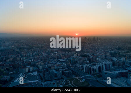 Aerial view of Milan skyline at dawn. Flying over building and boulevard. Stock Photo