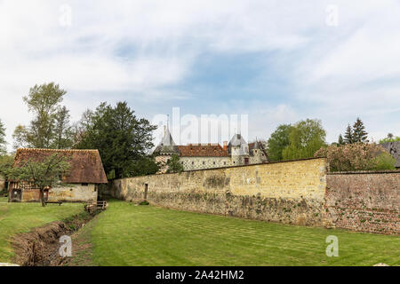 Saint Germain de Livet Château   wall with half timbered house in the background Stock Photo