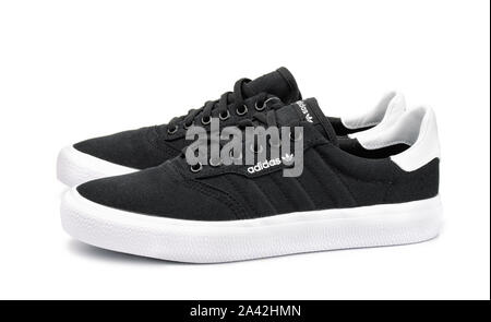Samara, Russia - September 2018. Product shot of black canvas Adidas sneakers isolated on white Stock Photo