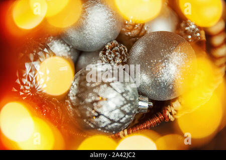 Christmas New Year Composition frame made of winter objects ornament balls pine cones in basket on dark black background. Flat lay top view copy space Stock Photo