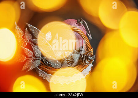 Christmas New Year Composition frame made of winter objects ornament balls pine cones in basket on dark black background. Flat lay top view copy space Stock Photo