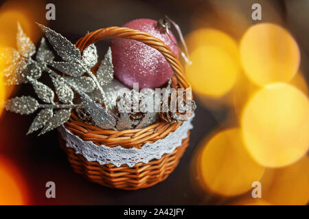 Christmas New Year Composition frame made of winter objects ornament balls pine cones in basket on dark black background. Flat lay top view copy space Stock Photo