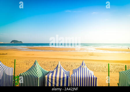 view of colorful tents of Zarauz beach, Pais Vasco, Spain, toned Stock Photo