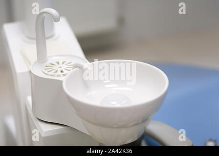 White washbasin in dentist clinic. Stomatological equipment. Stock Photo