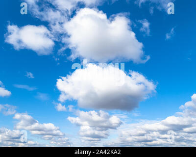 wedge of white cumulus clouds in blue sky on sunny autumn day Stock Photo
