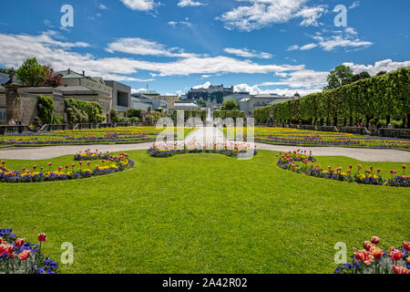 Salzburg, Austria - May 12 2017: Beautiful garden in Schloßpark Mirabell with Hohensalzburg Fortress on the Festungsberg, Salzburg, Austria Stock Photo