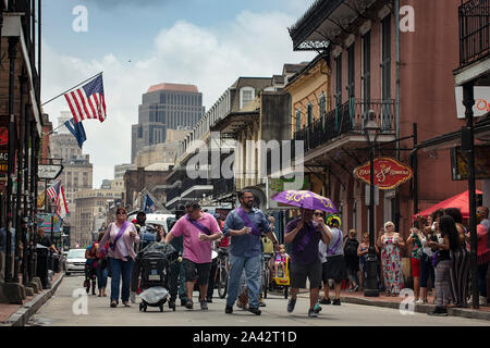 Second Line dancing along Bourbon Street in New Orleans Stock Photo