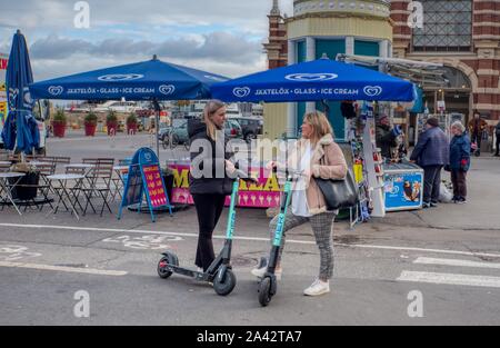 E-Scooters, couple on electric scooters, Helsinki, Finland Stock Photo
