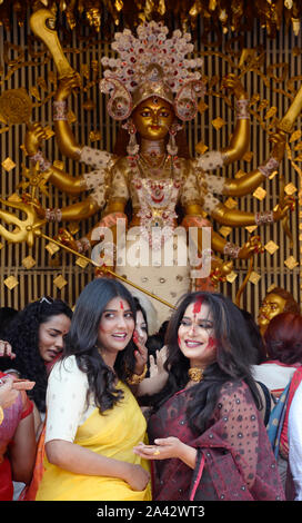 Kolkata, India. 11th Oct, 2019. Bengali Actress Parno Mitra and Ananya Chatterjee (left to right) take part in sindoor khela at a community puja pandal to celebrate the end of Durga Puja. (Photo by Saikat Paul/Pacific Press) Credit: Pacific Press Agency/Alamy Live News Stock Photo