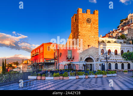 Taormina, Sicily, Italy: Panoramic view of the morning square Piazza IX Aprile with the Clock Tower and Mount Etna Volcano on background, in the sunri Stock Photo