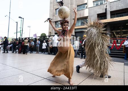 A woman is seen wearing an outfit to represent the fertility of Mother Earth.  People are seen dancing on Calle Madero in the centre of Mexico City.  The dance is performed to represent Mother Earth and her fight against the elements.  Lexie Harrison-Cripps Stock Photo