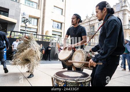 People are seen dancing and drumming on Calle Madero in the centre of Mexico City.  Lexie Harrison-Cripps Stock Photo