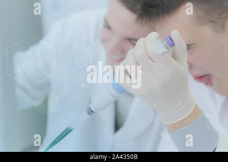 Two young male scientists doing experiments in laboratory Stock Photo