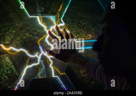 Woman touching plasma panel display Stock Photo