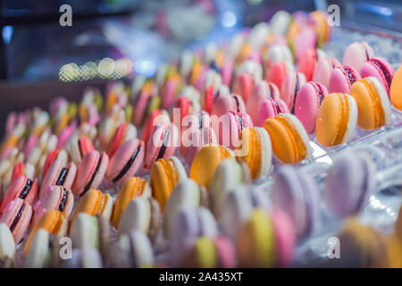 Assortment of colorful macarons cakes for sale on counter of candy shop Stock Photo