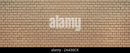 Old brick wall, completely painted over with beige paint Stock Photo
