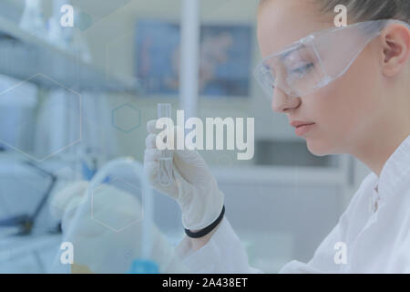 Young female scientist doing experiments in laboratory Stock Photo