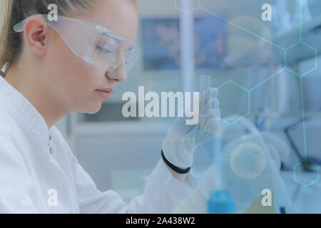 Young female scientist doing experiments in laboratory Stock Photo