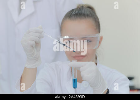 Young female scientist doing experiments in laboratory Stock Photo