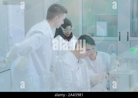 Group of young  scientists doing experiments in laboratory Stock Photo