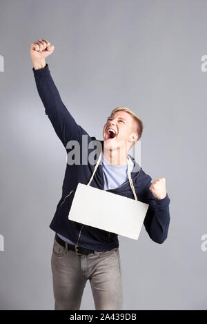 Happy successful man presenting empty signboard. Stock Photo
