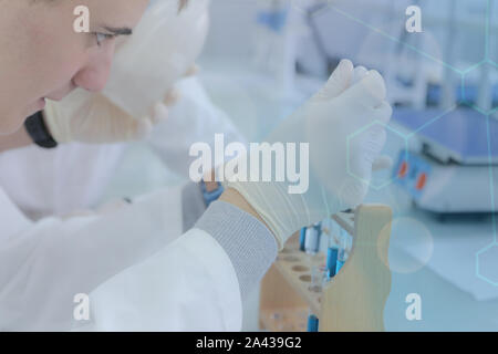 Young male scientist doing experiments in laboratory Stock Photo