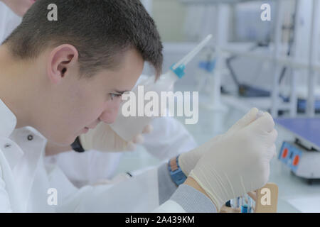 Young male scientist doing experiments in laboratory Stock Photo