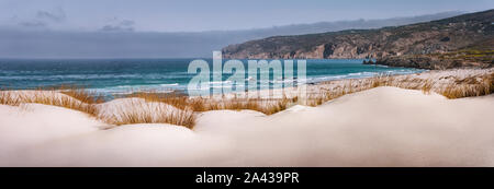 Panoramic costal view of Praia do Guincho Beach with Cresmina Dunes in foreground. Cascais, Portugal. Atlantic ocean spot for surfing, windsurfing and Stock Photo