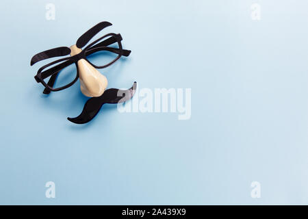 Carnival mask with moustache, nose and glasses on blue background, copy space. Concept men's health, prostate cancer awareness month, charity, Father' Stock Photo