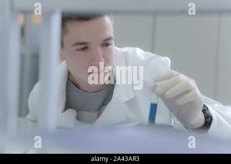 Young male scientist doing experiments in laboratory Stock Photo