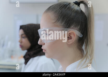 Two multiethnic young female scientists doing experiments in laboratory Stock Photo
