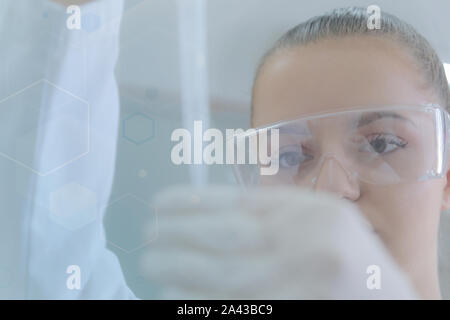 Young female scientist doing experiments in laboratory Stock Photo