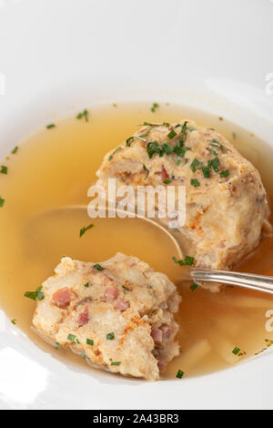 single speckknoedel in soup on wood Stock Photo