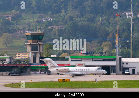 Agno, Ticino, Switzerland - 6th October 2019 : View on the Lugano-Agno airport with a parked small airplane located in the Canton of Ticino, Switzerla Stock Photo