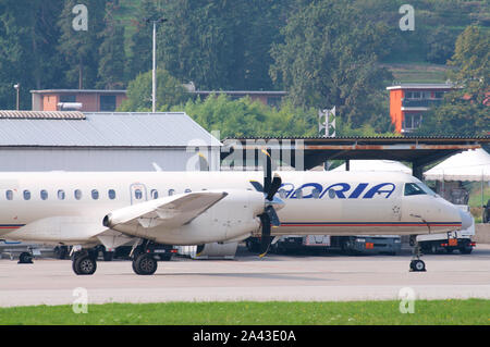 Agno, Ticino, Switzerland - 6th October 2019 : View on the Lugano-Agno airport with a parked air Adria Airplane located in the Canton of Ticino, Switz Stock Photo