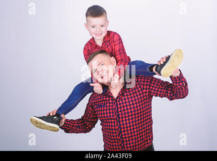 childhood. parenting. fathers day. happy family. father and son in red checkered shirt. little boy with dad man. Serious and confident cowboy. Playing together. Enjoying playtime. Summer fun. Stock Photo