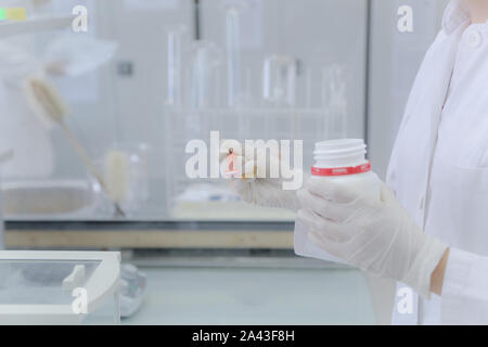 Weighting of ascorbic acid in chemical laboratory. Stock Photo